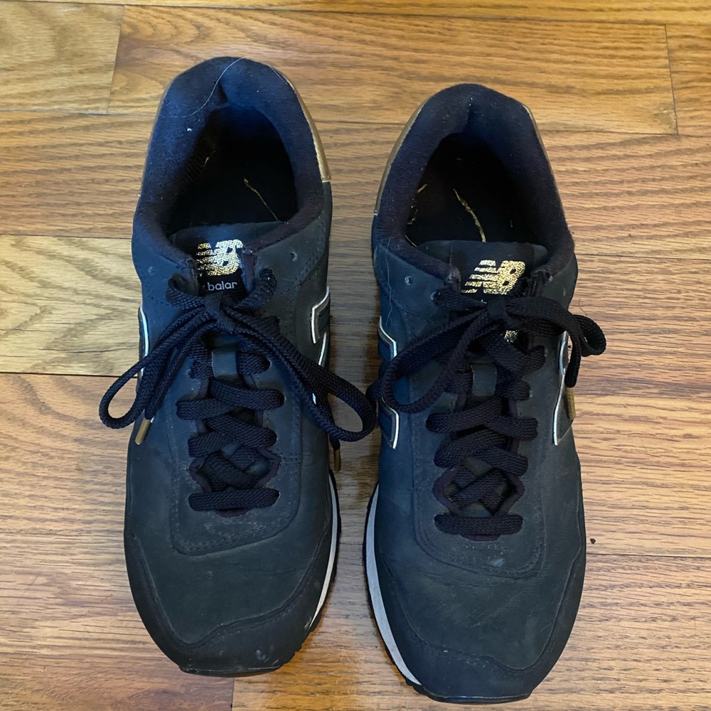 Women’s black and gold new balance sneaker.